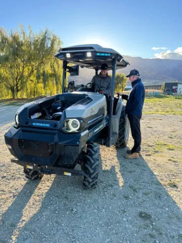 Guides talking in front of the electric tractor